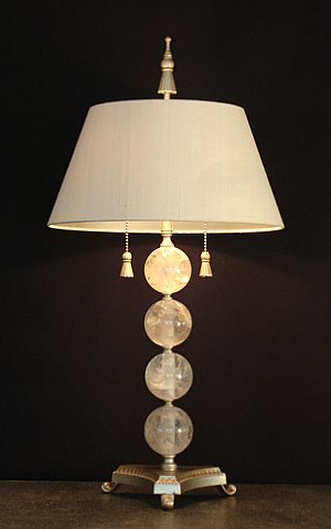 Rock crystal table lamp on a tripod base with four rock crystal spheres, tassel pulls and finial and a white raw silk shade from Empel Collections