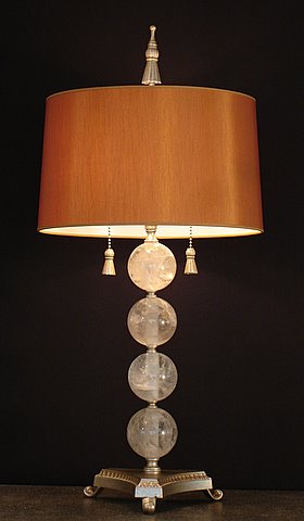 Rock crystal table lamp on a tripod base with four rock crystal spheres, tassel pulls and finial and a Cognac raw silk shade from Empel Collections