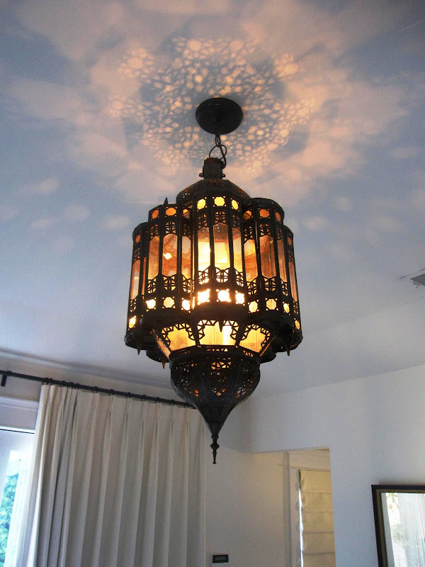 Large Moroccan style metal lantern in a beach house bedroom