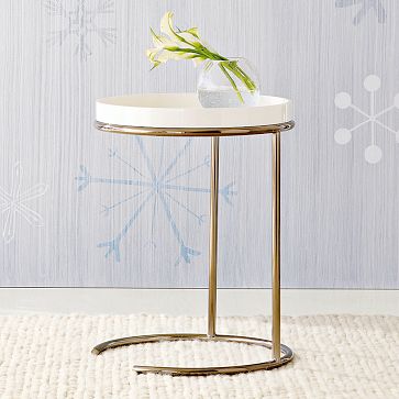 Side table with a round top with removable lacquer wood tray on polished bronze base from West Elm
