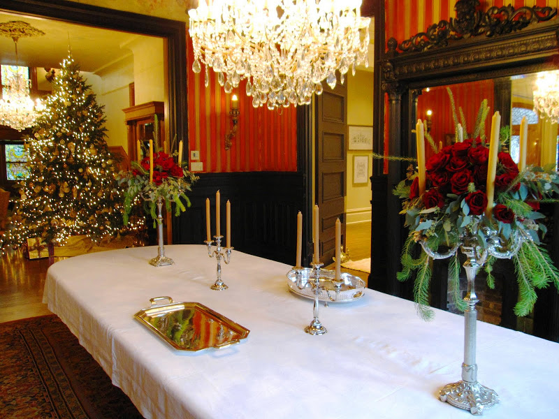 Rose filled candelabras on the dining room table before a party in a historic New Orleans mansion