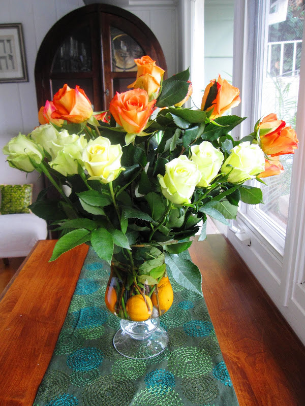 Flower arrangement made with Clementine oranges, orange and green roses