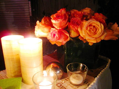 Flower arrangement with pink and orange roses with a silver ball tree ornament at an outdoor holiday party