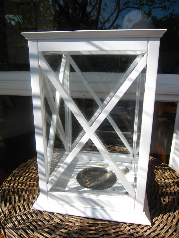 White hurricane lantern from William Sonoma Home on a deck in the Hollywood Hills