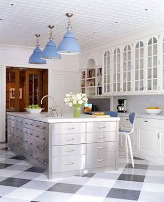 Kitchen with stainless steel island cabinets, a pressed tin ceiling, cornflower blue dome pendant lights and checkered floor
