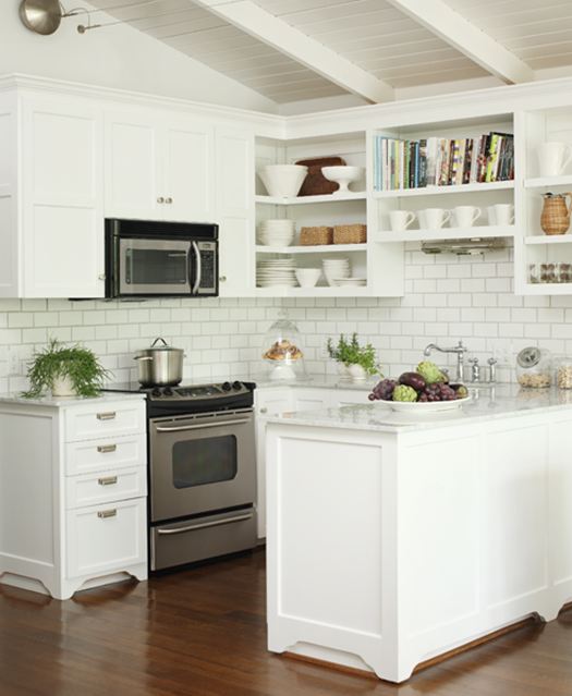 Small kitchen in a lake house with marble countertops, stainless steel appliances, open shelving, white cabinets and white subway tile backsplash