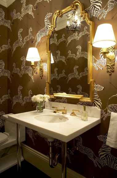 Powder room with zebra print wallpaper and gold hardware