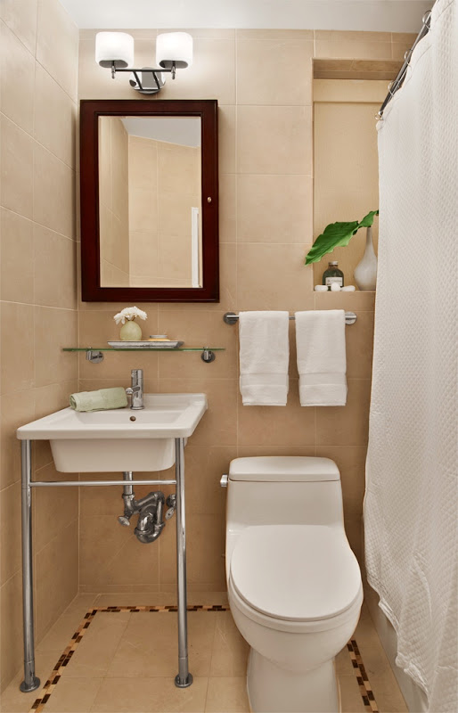 Small New York City bathroom with beige floor and ceiling tiles and white fixtures and towels