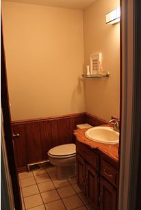 Bathroom with tile floor and wood cabinets