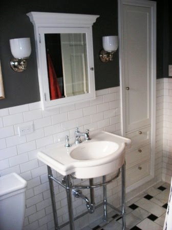 Bathroom in a designer's home with gigantic basketweave mosaic tile and a modern sink