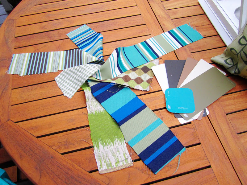 Swatches of fabric and paint on a teak patio table