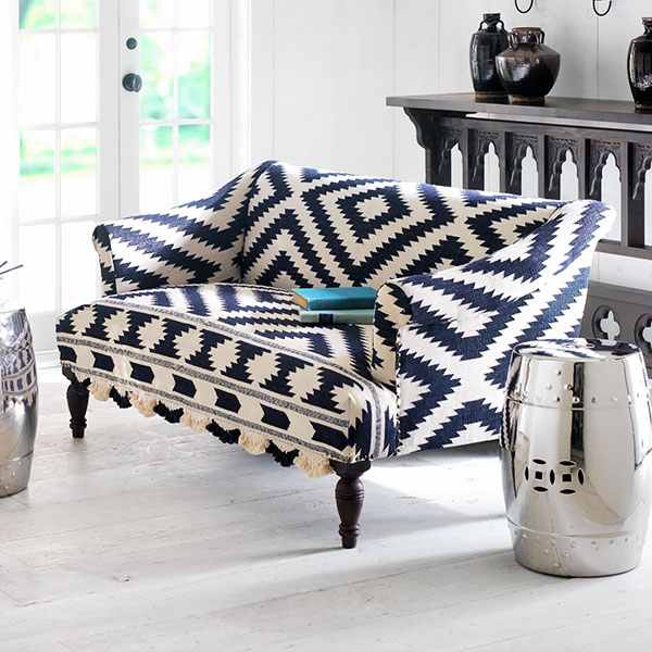 Navy and white wooden upholstered sofa with bridal rug from Wisteria