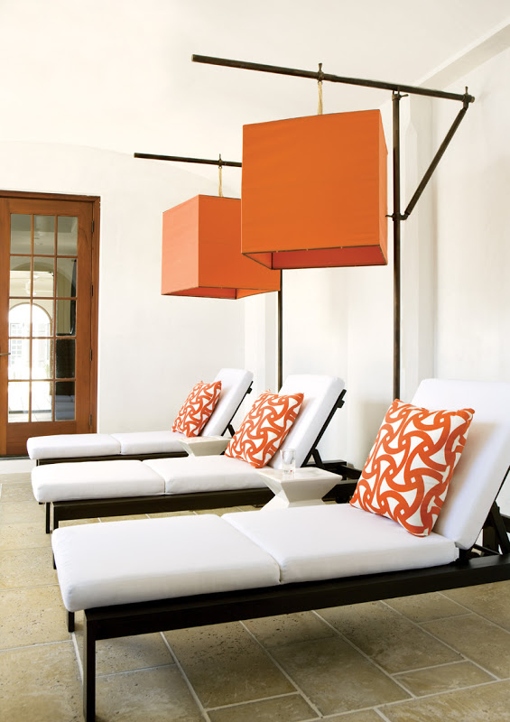 Outdoor chaise lounge chairs with orange Trina Turk designed Santorini outdoor fabric pillows