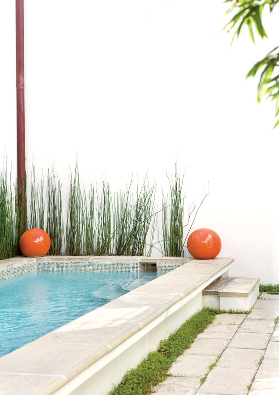 Two huge orange balls flank the lap pool in a Florida beach house