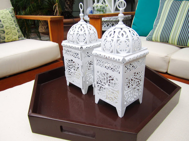 Two white metal Moroccan style lanterns on brown tray