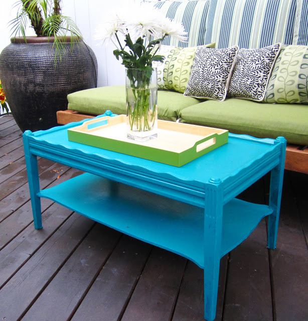 Outdoor deck with bright blue coffee table and lime green tray