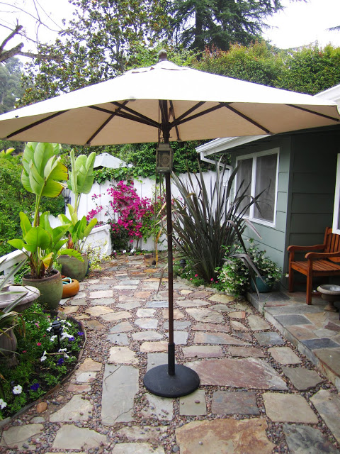 Sand color 9' market umbrella and metal umbrella stand