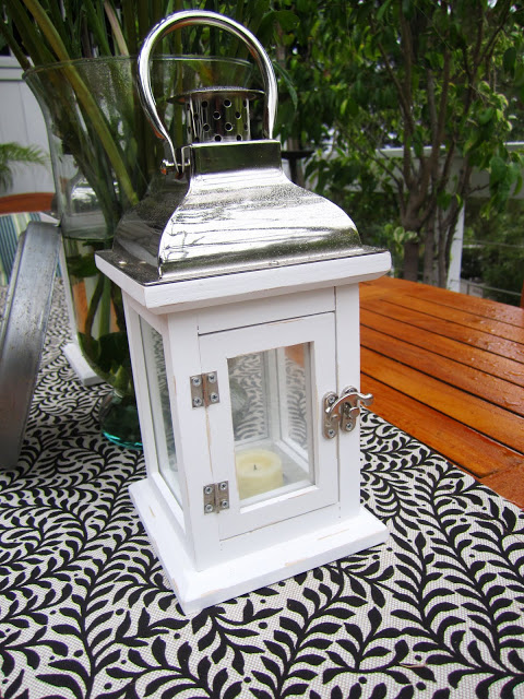 White wood lantern on an outdoor dining table
