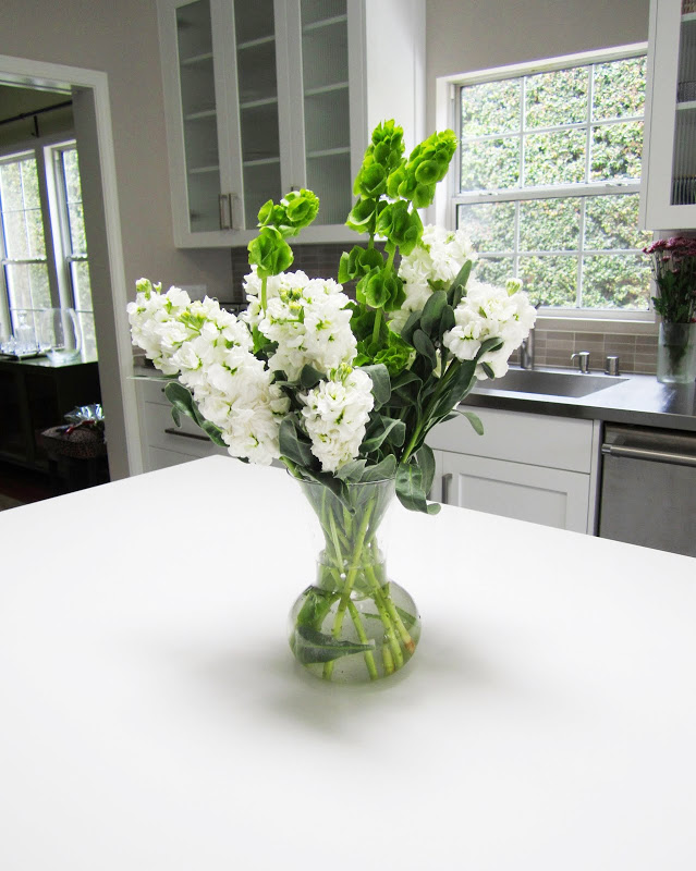 Flower arrangement on a white kitchen island
