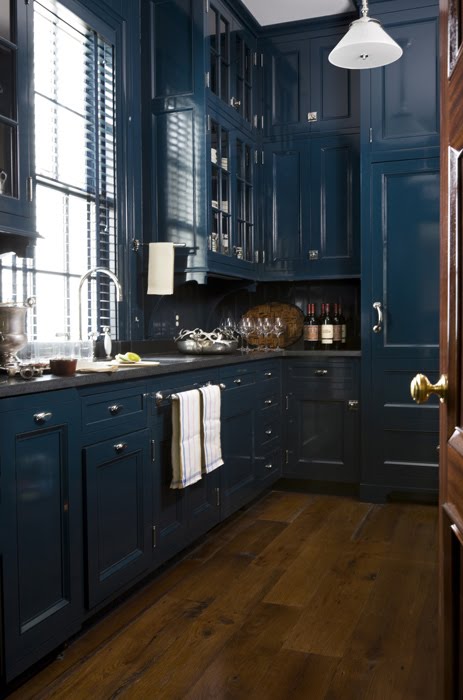 Traditional kitchen with dark blue cabinets and a wood floor