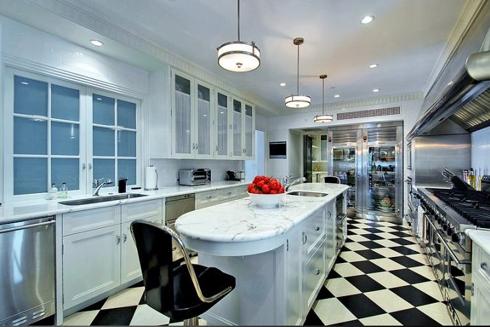 Gourmet kitchen in a Paul Willims designed home with state of the art appliances, custom cabinetry, Carrera marble counters and wonderful black and white checkered floor