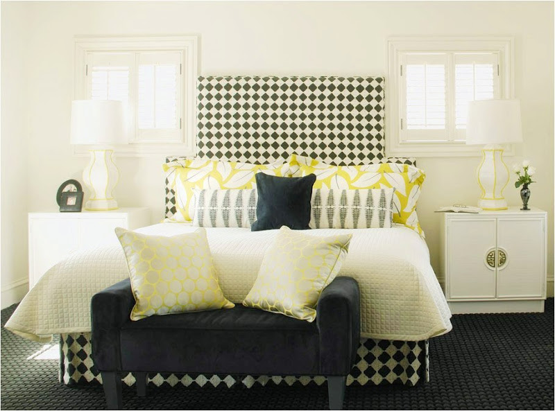  Master bedroom with black and white harlequin patterned upholstered bed and yellow accents