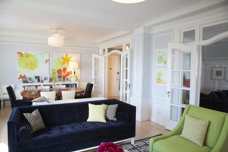 Living room with Madeline Weinrib rugs,navy sofas and bright blue armchairs and a view of the dining room