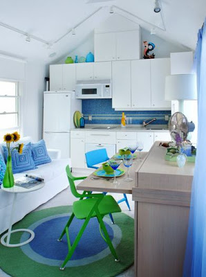 Small, bright white kitchen with bright green and blue accents