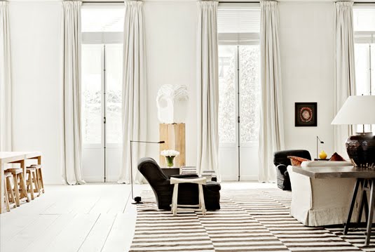 Rustic white living room with brown and white rug with a drop step pattern