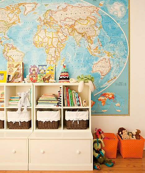 Children's room with a large map of the world and brown and orange wicker storage baskets