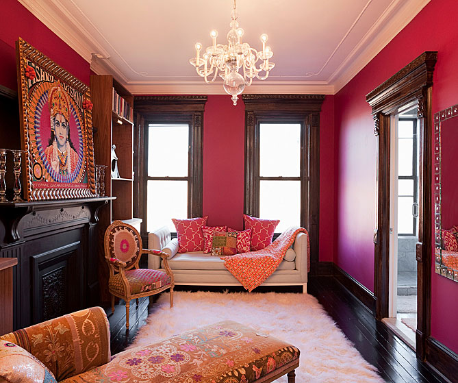 Fuchsia dressing room/lounge with a glass chandelier, custom cabinets and refinished wood floor