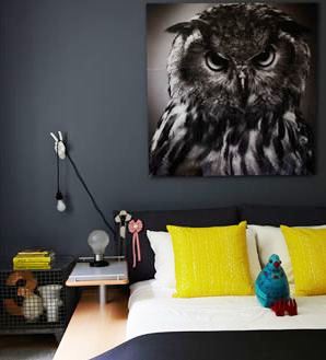 Dark bedroom with a large portrait of an owl