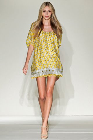 model from Collette Dinnigan's Spring 2011 Ready-to-Wear fashion show wearing a short yellow dress
