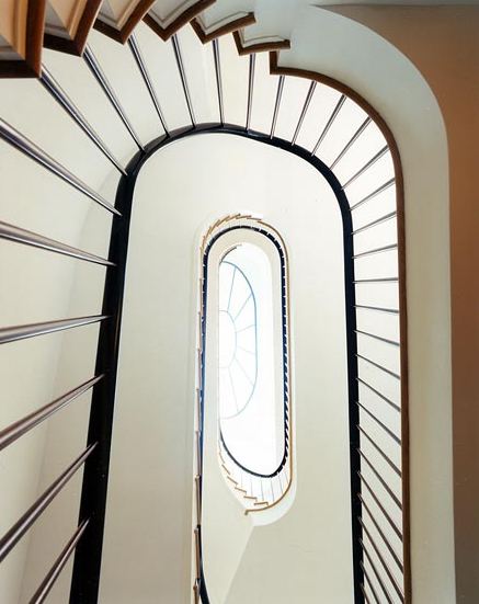 spiraling staircase with oval skylight