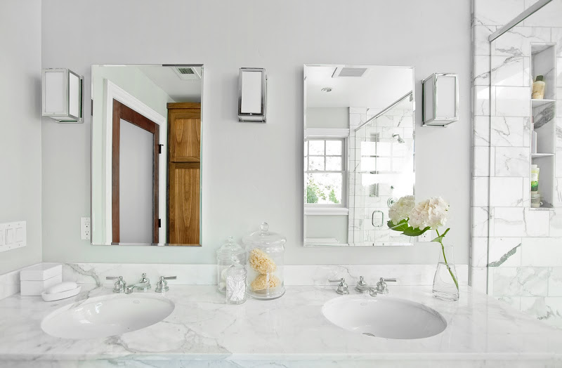 Bathroom with two sinks and mirors, Carrara marble counter top and chrome fixtures, faucets and fittings