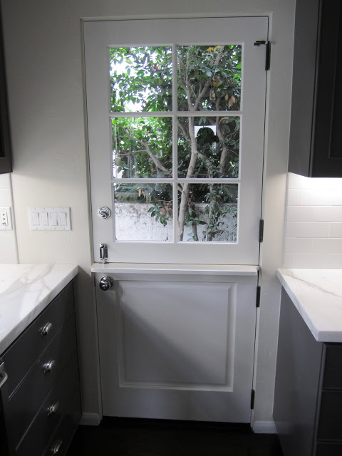 White dutch side door with paned window in a grey kitchen