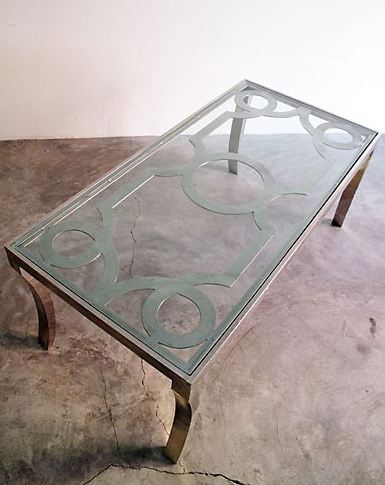 Iron coffee table with loop detaling and a glass top