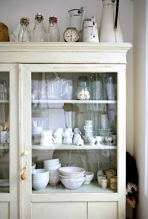 White china cabinet in a white rustic eat in kitchen