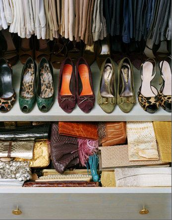 Close up of a shoe rack in a well organized closet and a slightly opened drawer showing how wallets and clutch purses are organized
