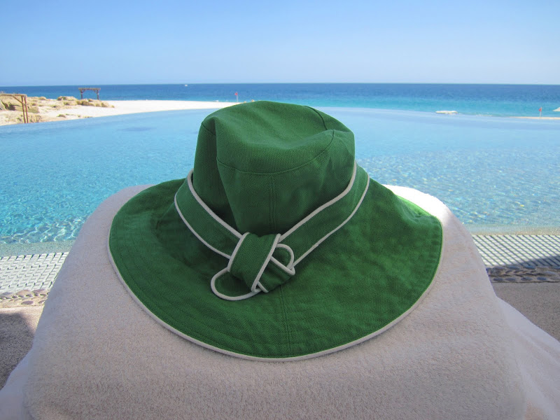 Green hat with white piping on a beach chair in Los Cabos Mexico
