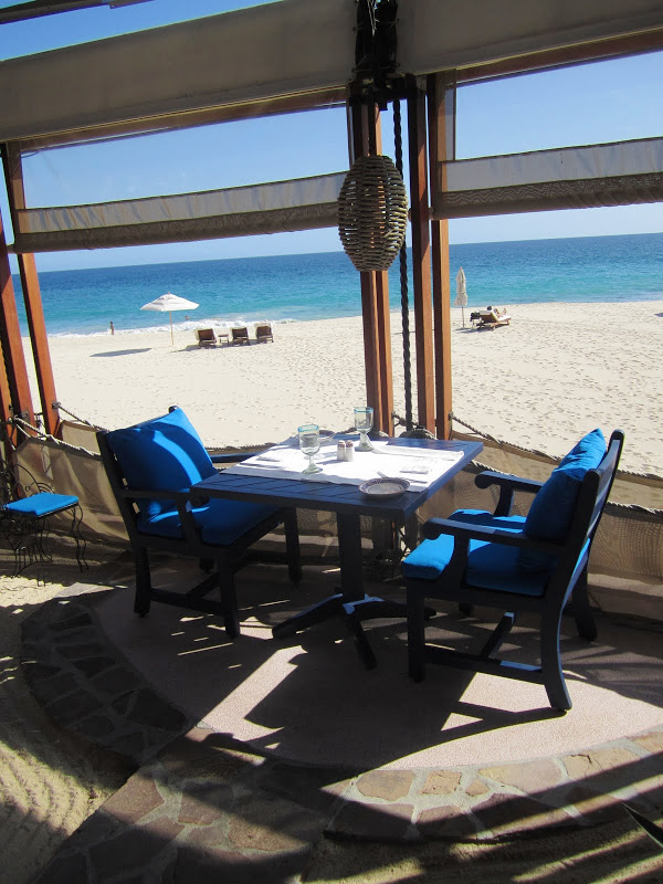 Two person table in a restaurant on the beach at a resort in mexico