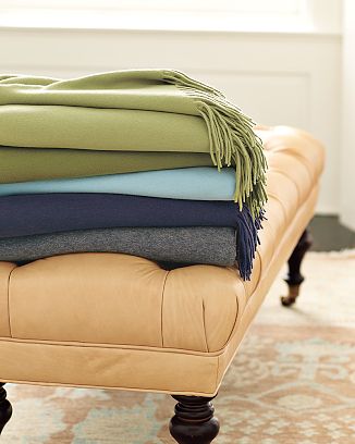 Solid Cashmere Throws on a tan tufted ottoman