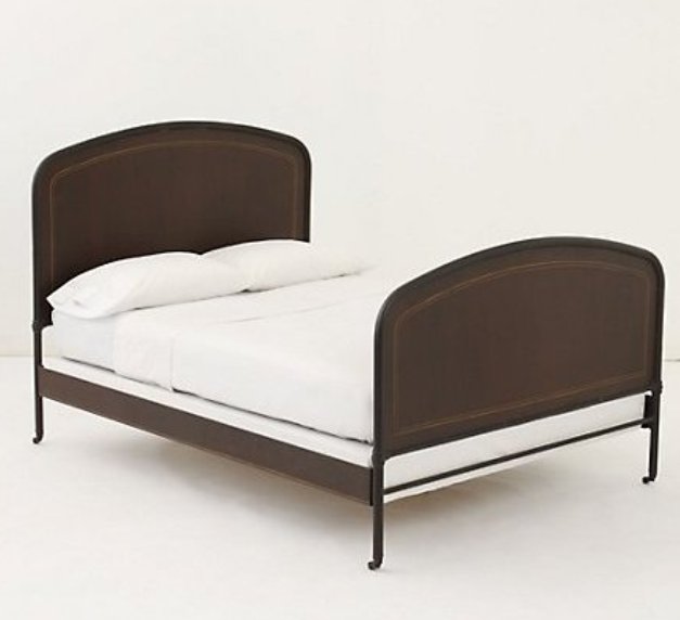 Black iron bed with arched headboard and footboard