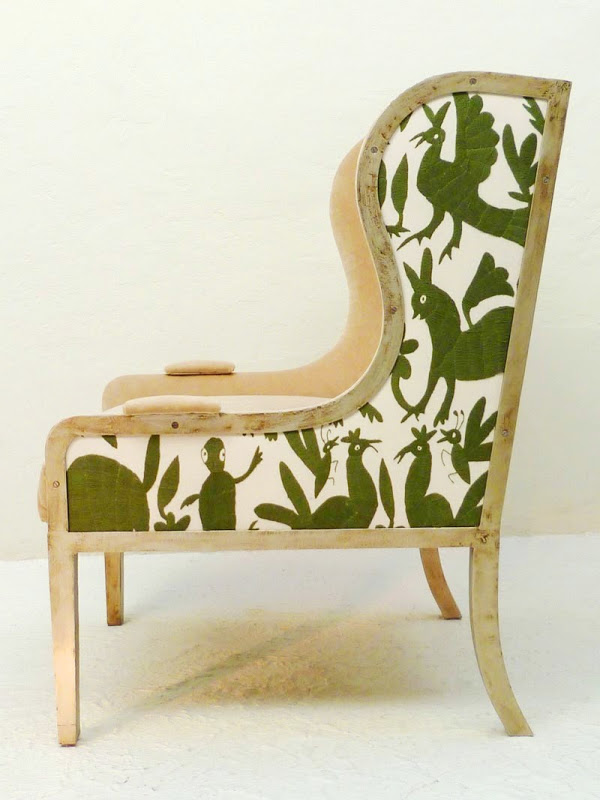 Side view of Ixelles Wing back chair with seat and back upholstered in white with green animals and plants by Casamidy