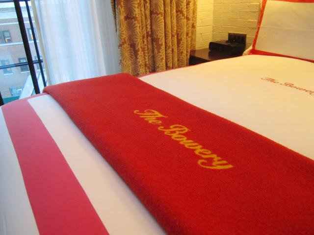 Close up of The Bowery throw on the bed at The Bowery Hotel