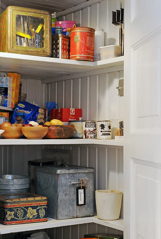 Pantry with beadboard walls and white shelves