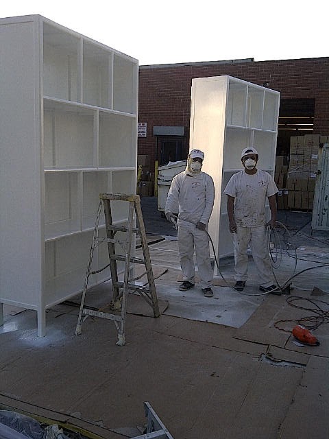 9 foot display cases in the process of being painted white