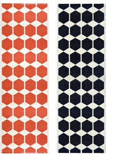 Plastic, washable rugs from Brita Sweden in orange and black hexagon pattern