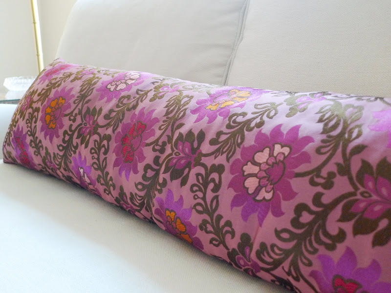 Close up of the long pink pillow and the gorgeous flower pattern on it