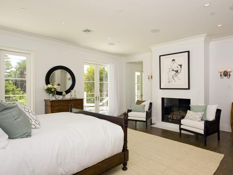 Master bedroom with a fireplace, french doors leading outdoors and a sisal rug